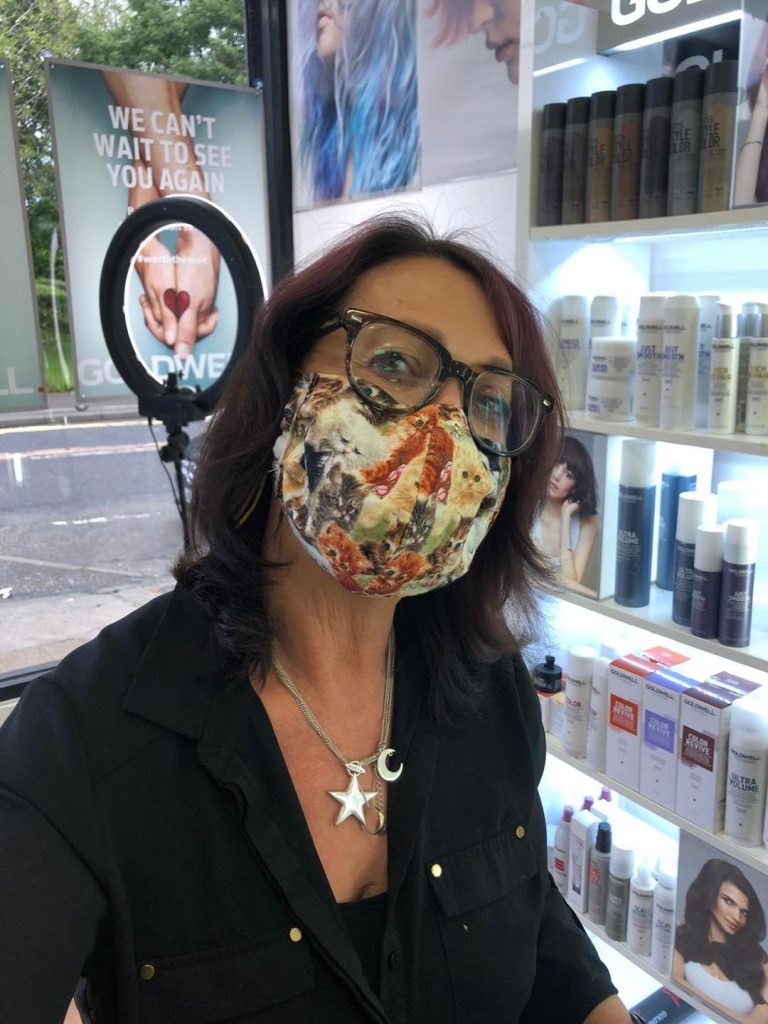 Stylist and Goldwell Master Colourist, Christine Cairns wearing her face covering